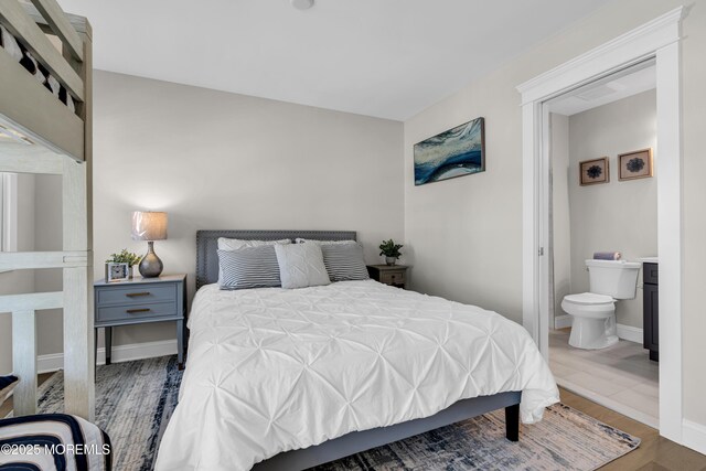 6 Shell Rd, Mantoloking, NJ 08738 - bedroom with ensuite bath, wood finished floors, and baseboards