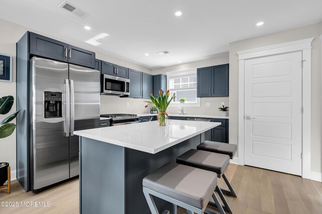6 Shell Rd, Mantoloking, NJ 08738 - kitchen with stainless steel appliances, a kitchen breakfast bar, light wood-type flooring, light countertops, and recessed lighting