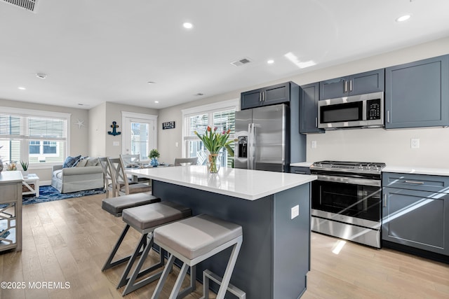 6 Shell Rd, Mantoloking, NJ 08738 - kitchen featuring appliances with stainless steel finishes, light wood-style flooring, a breakfast bar, light countertops, and recessed lighting