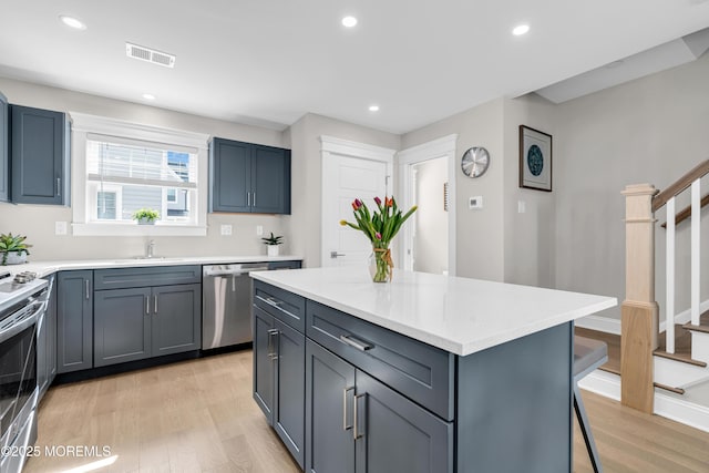 6 Shell Rd, Mantoloking, NJ 08738 - kitchen featuring appliances with stainless steel finishes, light wood-type flooring, light countertops, a kitchen bar, and recessed lighting