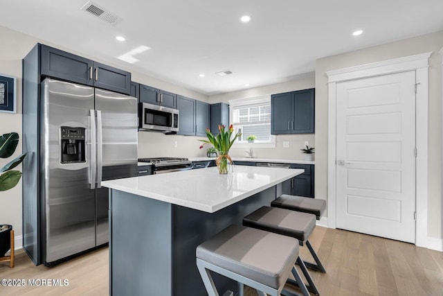 6 Shell Rd, Mantoloking, NJ 08738 - kitchen featuring stainless steel appliances, a breakfast bar area, light wood-type flooring, light countertops, and recessed lighting