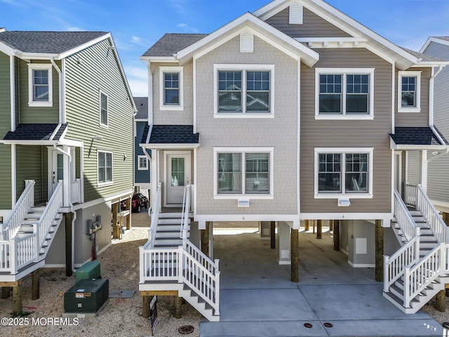 6 Shell Rd, Mantoloking, NJ 08738 - view of front facade with stairs, a carport, concrete driveway, and a shingled roof
