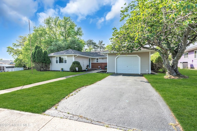 single story home with a front lawn, asphalt driveway, a garage, and central AC