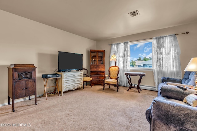 sitting room featuring carpet, a baseboard heating unit, and baseboards