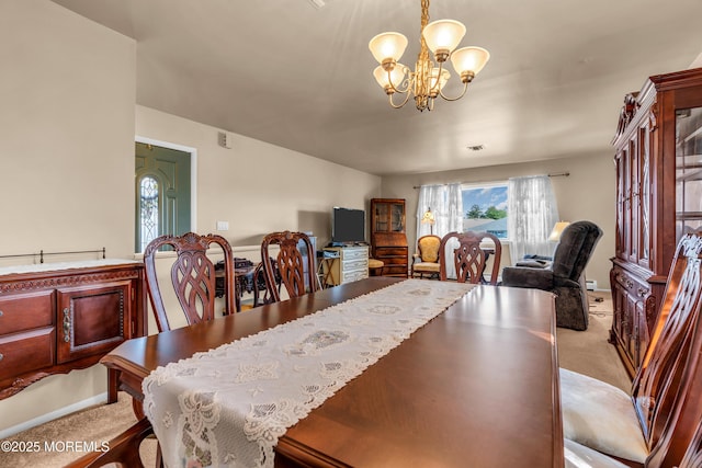 carpeted dining space featuring a chandelier and baseboards
