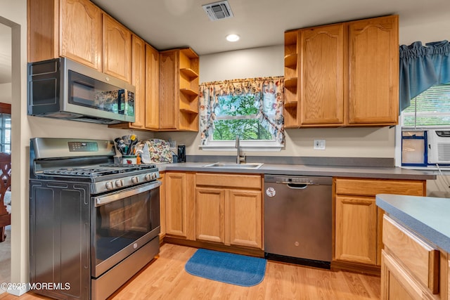 kitchen with stainless steel appliances, a sink, open shelves, light wood-style flooring, and recessed lighting