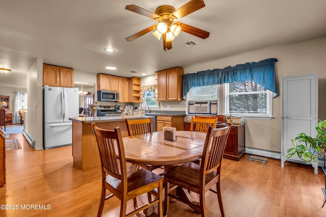 dining room featuring a baseboard heating unit, light wood-type flooring, ceiling fan, cooling unit, and recessed lighting
