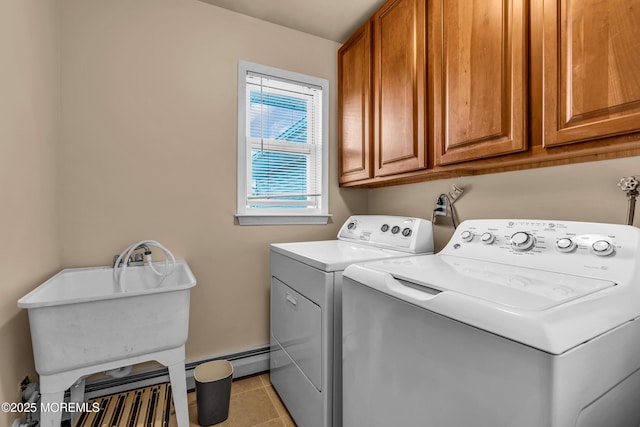 laundry area featuring cabinet space, separate washer and dryer, and light tile patterned floors