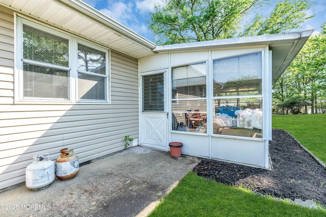 property entrance with a patio, crawl space, and a lawn