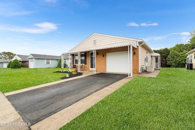 9 Zapata Ct, Toms River, NJ 08757 - view of front facade featuring an attached garage, asphalt driveway, a front yard, brick siding, and central AC