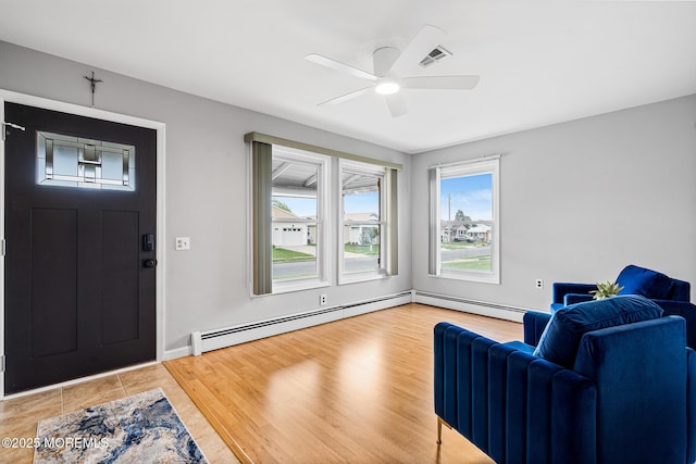 9 Zapata Ct, Toms River, NJ 08757 - entryway featuring ceiling fan, a baseboard heating unit, and light wood-style floors