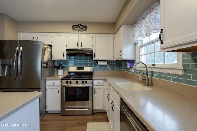 204 Stormy Rd, Manahawkin, NJ 08050 - kitchen with appliances with stainless steel finishes, under cabinet range hood, a sink, and white cabinets