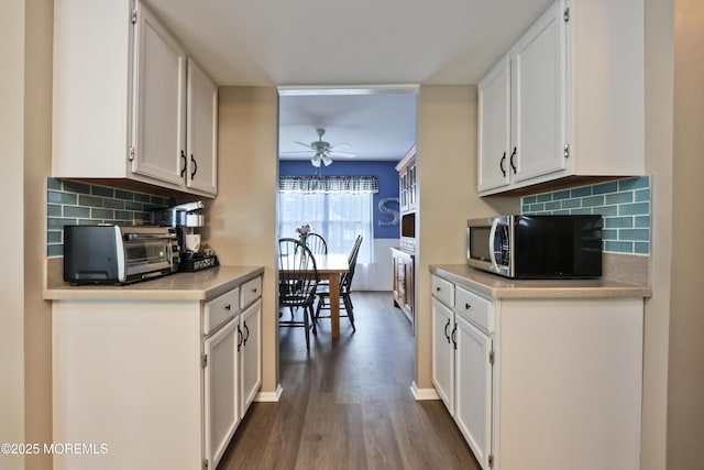 204 Stormy Rd, Manahawkin, NJ 08050 - kitchen with stainless steel microwave, a ceiling fan, white cabinets, wood finished floors, and backsplash