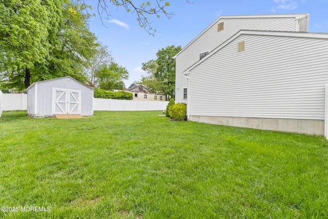 view of yard featuring a shed and an outbuilding