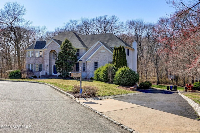 460 Christine Ct, Freehold, NJ 07728 - traditional home with a chimney, a front yard, and stone siding