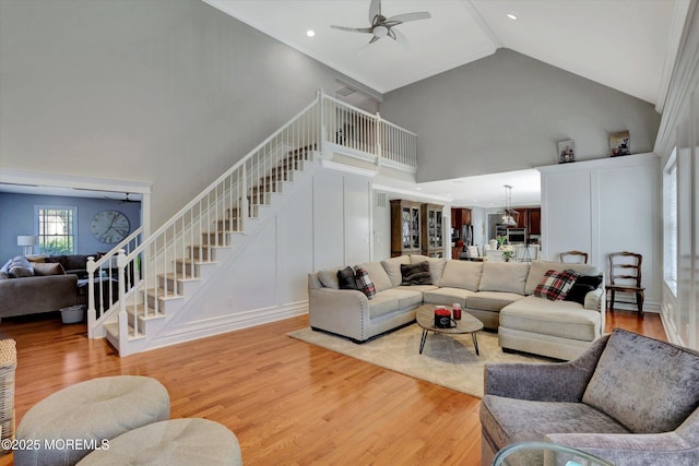 460 Christine Ct, Freehold, NJ 07728 - living room with light wood-style floors, stairway, a ceiling fan, and high vaulted ceiling