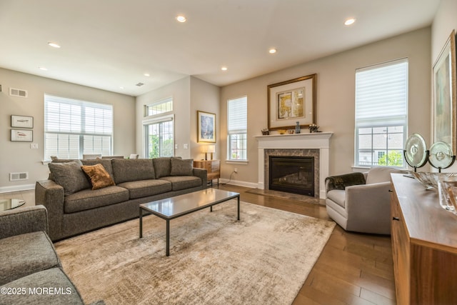 9 Anvil Way, Freehold, NJ 07728 - living area featuring wood finished floors, recessed lighting, plenty of natural light, a tiled fireplace, and baseboards