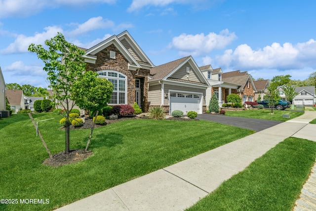 9 Anvil Way, Freehold, NJ 07728 - view of front facade featuring stone siding, driveway, a garage, and a front yard