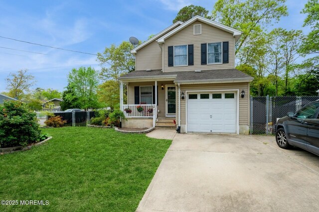 traditional-style house with a garage, covered porch, and driveway