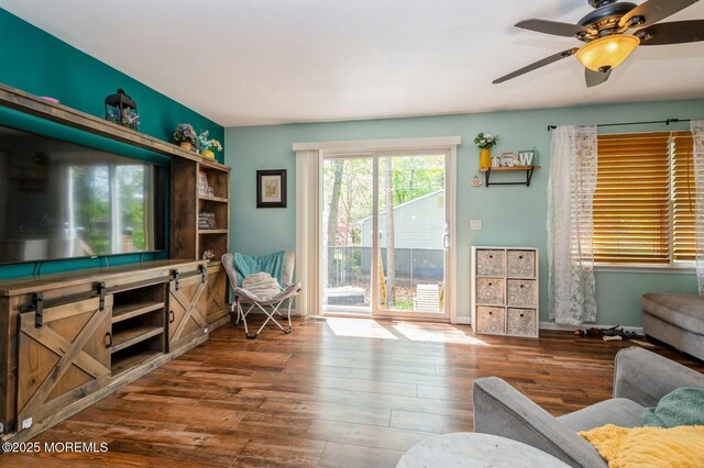 living area featuring wood finished floors and a ceiling fan