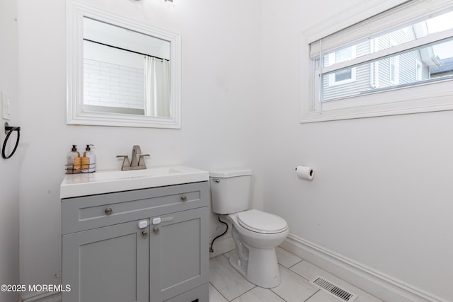 full bath featuring baseboards, toilet, and vanity