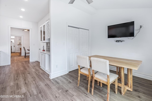 dining area with a ceiling fan, light wood-style flooring, recessed lighting, and baseboards