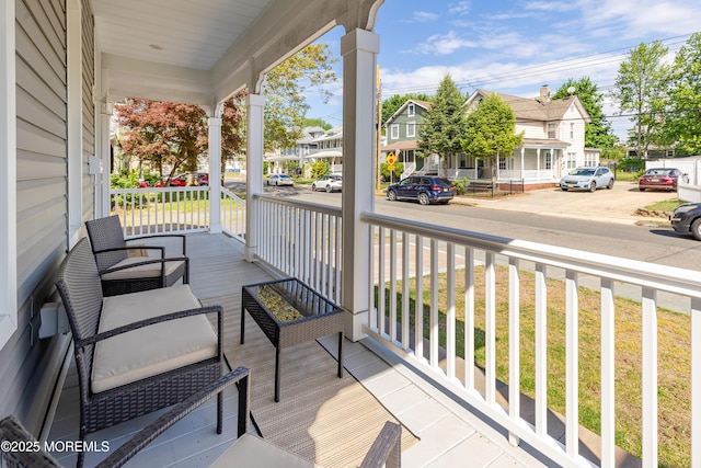 deck featuring a porch and a residential view
