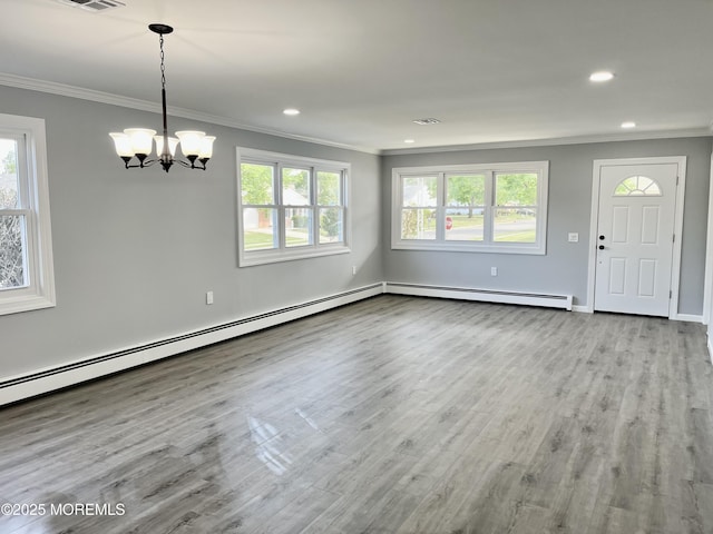 entryway featuring ornamental molding, baseboard heating, a chandelier, wood finished floors, and recessed lighting