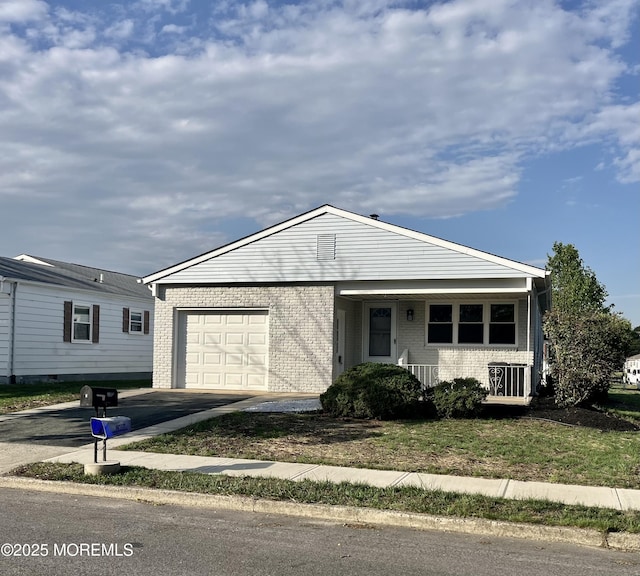 ranch-style house with an attached garage, brick siding, asphalt driveway, and a front lawn