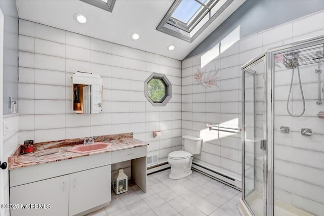 733 Colts Neck Rd, Freehold, NJ 07728 - full bathroom featuring a baseboard heating unit, tile walls, a skylight, a baseboard radiator, and toilet