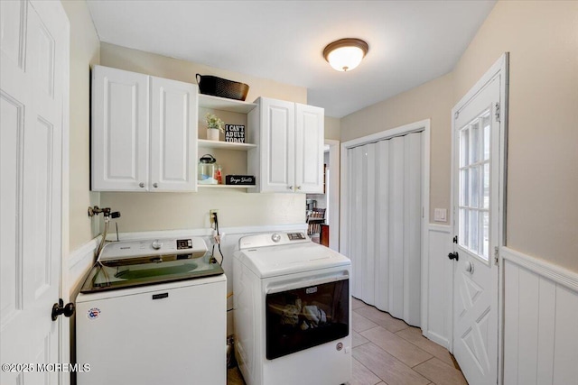 733 Colts Neck Rd, Freehold, NJ 07728 - clothes washing area featuring washing machine and clothes dryer, wainscoting, and cabinet space