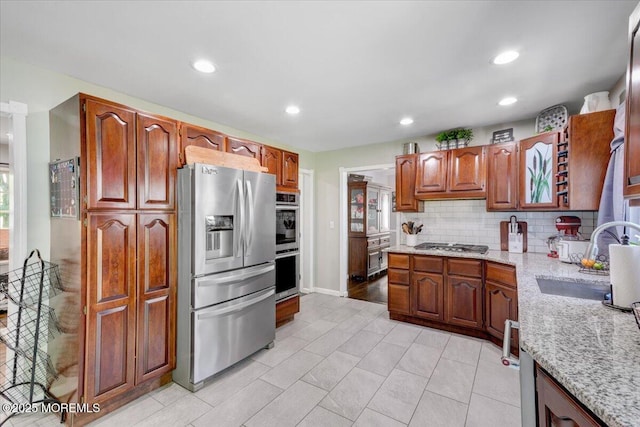733 Colts Neck Rd, Freehold, NJ 07728 - kitchen with appliances with stainless steel finishes, a sink, decorative backsplash, light stone counters, and recessed lighting