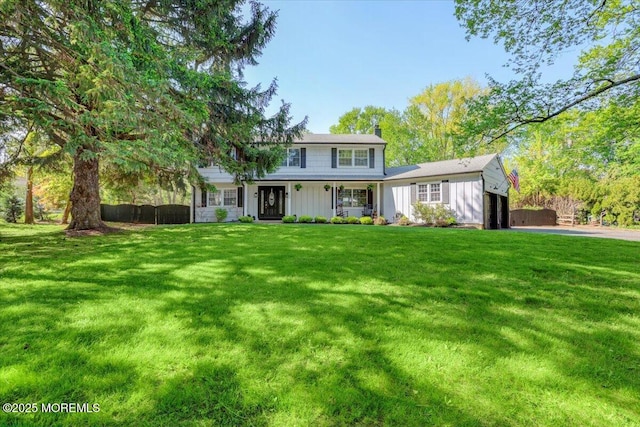 733 Colts Neck Rd, Freehold, NJ 07728 - view of front of home with board and batten siding, an attached garage, a front lawn, and covered porch