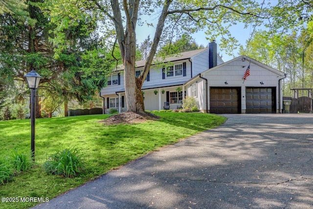 733 Colts Neck Rd, Freehold, NJ 07728 - traditional-style house featuring a chimney, a garage, and asphalt driveway