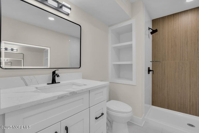 full bath featuring vanity, toilet, a shower stall, and built in shelves