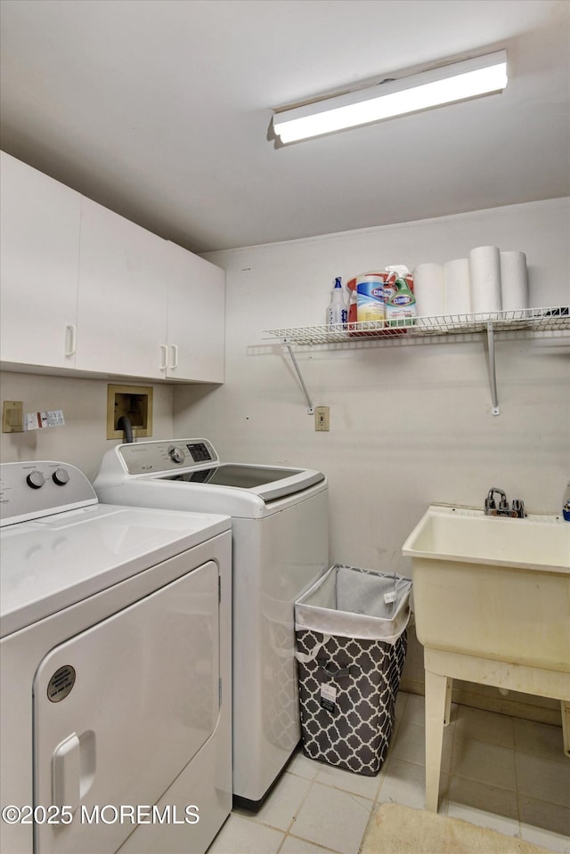 laundry area featuring cabinet space, independent washer and dryer, and light tile patterned floors