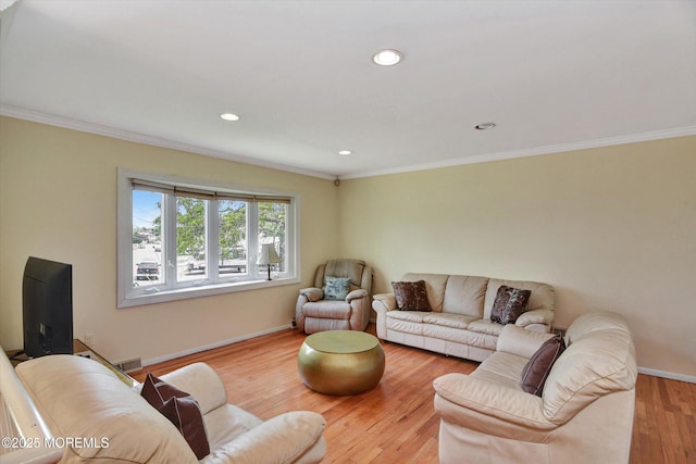 living area with wood finished floors, baseboards, ornamental molding, and recessed lighting