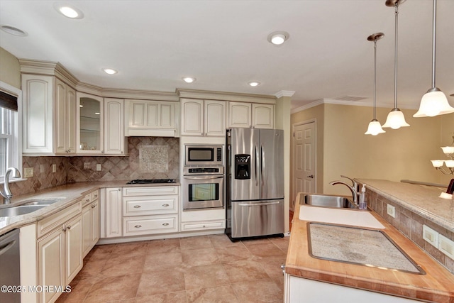 kitchen featuring cream cabinets, a sink, and appliances with stainless steel finishes