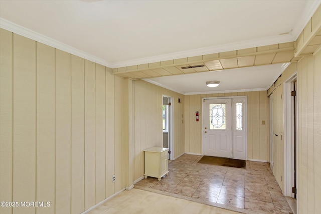 entrance foyer featuring ornamental molding, baseboards, and visible vents