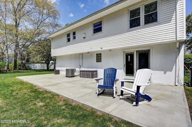back of house featuring fence, a yard, a patio, stucco siding, and cooling unit