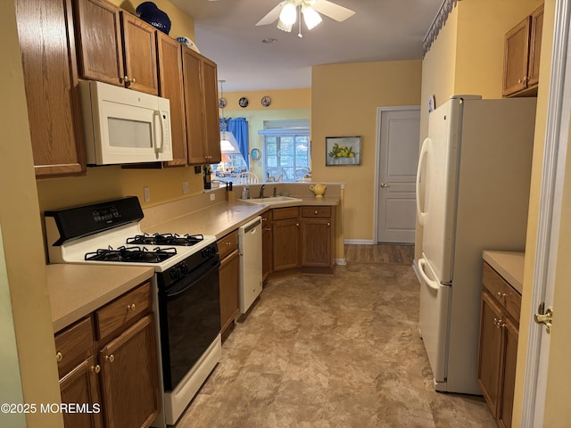 14 Pelican Ln, Little Egg Harbor, NJ 08087 - kitchen featuring white appliances, light flooring, ceiling fan, and brown cabinetry