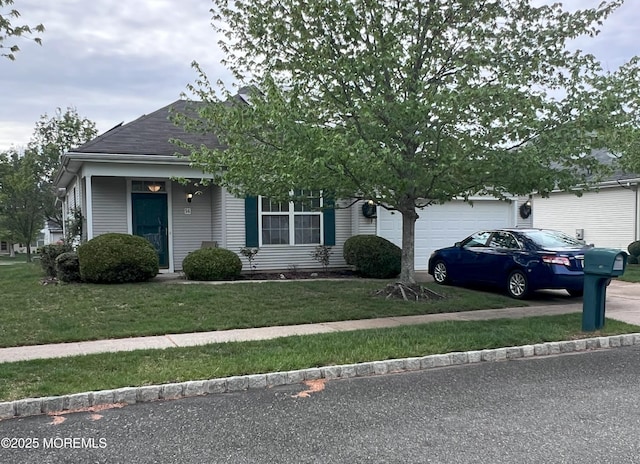 14 Pelican Ln, Little Egg Harbor, NJ 08087 - view of front of house featuring an attached garage, concrete driveway, a front yard, and roof with shingles