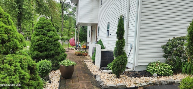 view of side of property with central air condition unit