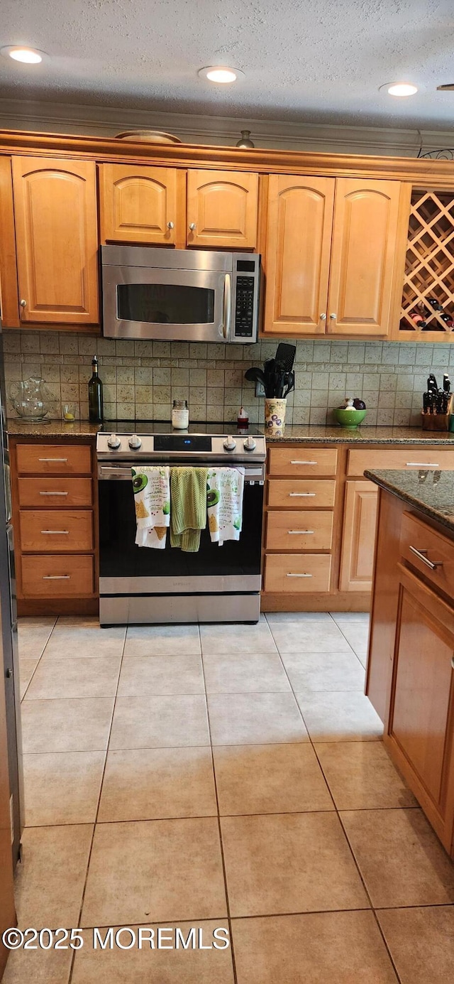 95 Gravel Hill Spotswood Rd, Monroe, NJ 08831 - kitchen featuring stainless steel appliances, dark stone counters, tasteful backsplash, a textured ceiling, and light tile patterned flooring