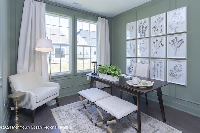 office featuring plenty of natural light, a decorative wall, and visible vents