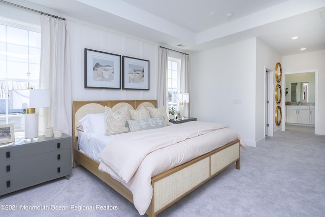 bedroom featuring baseboards, connected bathroom, recessed lighting, and light colored carpet
