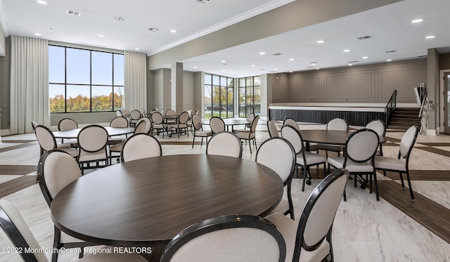 dining area featuring recessed lighting, crown molding, and plenty of natural light