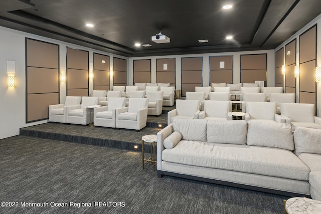 carpeted cinema room with a raised ceiling and recessed lighting