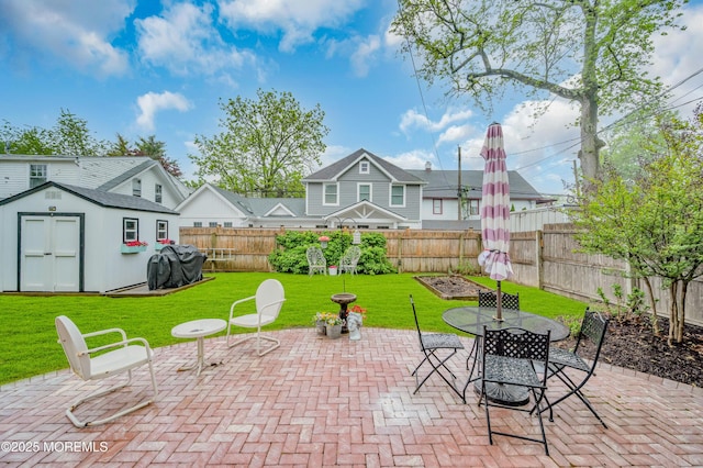 view of patio / terrace featuring a shed, an outbuilding, and outdoor dining area