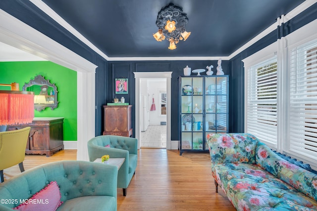living area featuring crown molding and wood finished floors